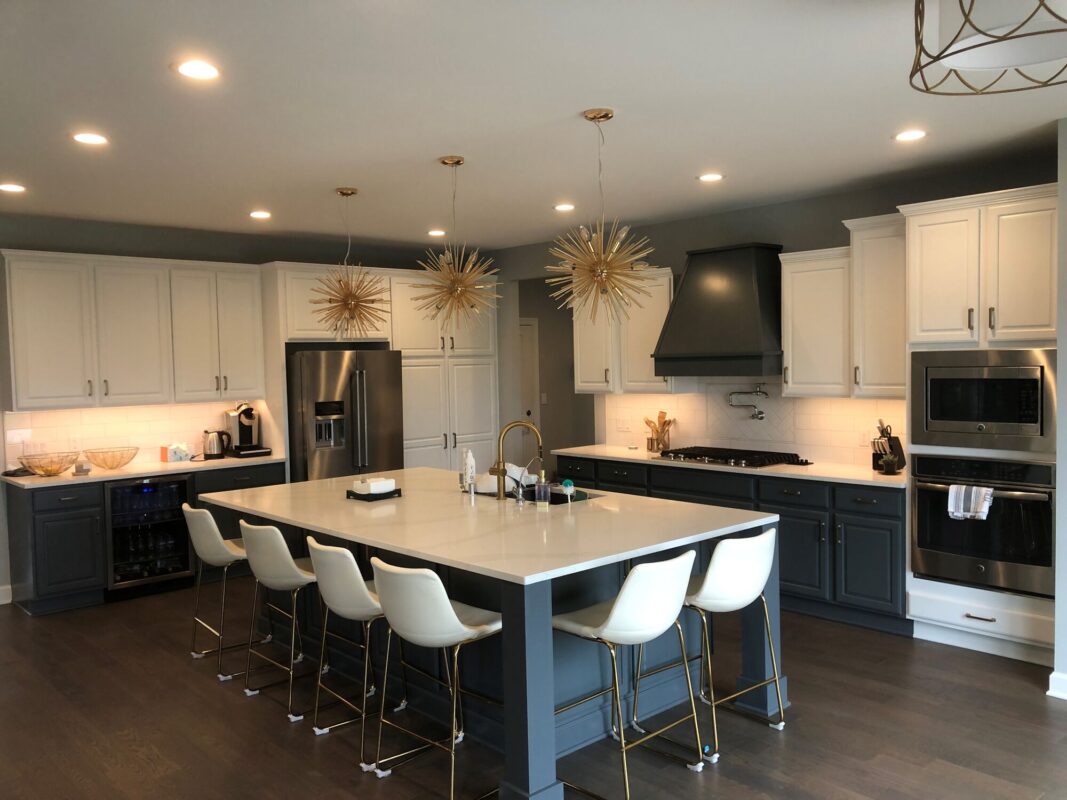modern custom kitchen with large island seating pendant lighting and white cabinetry