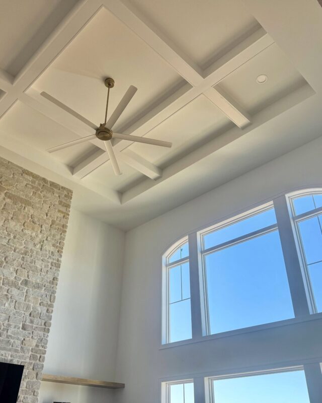 Morrow Home coffered ceiling with ceiling fan and large arched windows in great room